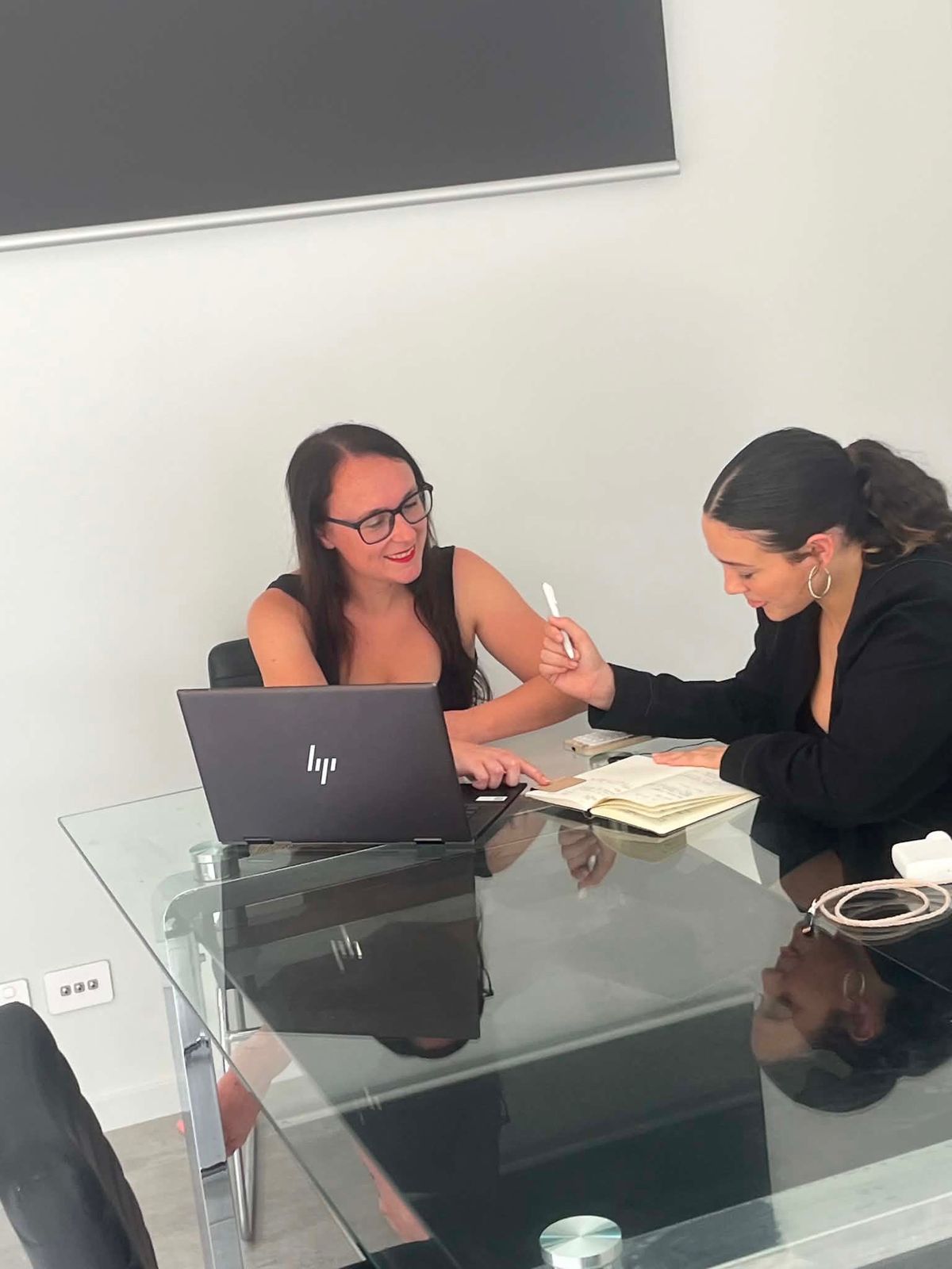 Courtney Moloney working with a colleague at CSM Solicitors